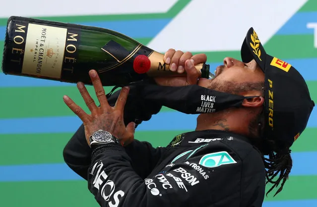 Race winner Lewis Hamilton of Great Britain and Mercedes GP celebrates on the podium during the F1 Eifel Grand Prix at Nuerburgring on October 11, 2020 in Nuerburg, Germany. (Photo by Matthias Schrader/Pool via Reuters)