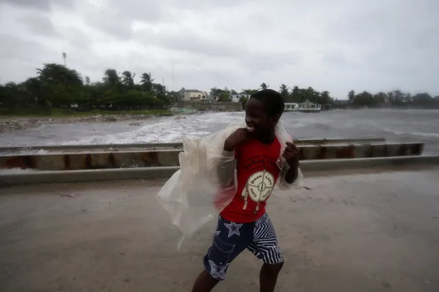 A boy walks along a pier ahead of Hurricane Matthew in Les Cayes, Haiti, October 3, 2016. (Photo by Andres Martinez Casares/Reuters)