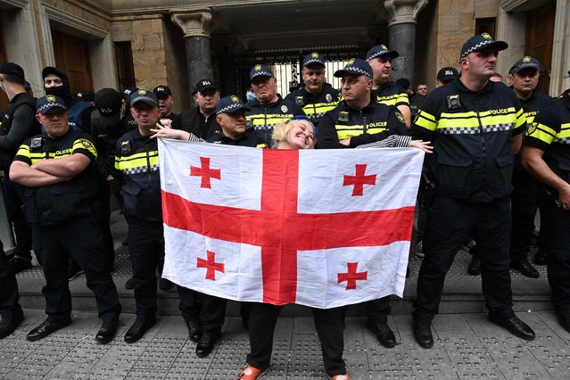 Demonstrators protesting the “foreign influence” law crowd outside the parliament building in central Tbilisi on May 28, 2024. Georgian lawmakers geared up on May 28, 2024 to overturn a presidential veto and push through a controversial “foreign influence” bill that opponents say will place onerous restrictions on foreign-funded NGOs and derail the country's path to the European Union. (Photo by Vano Shlamov/AFP Photo)