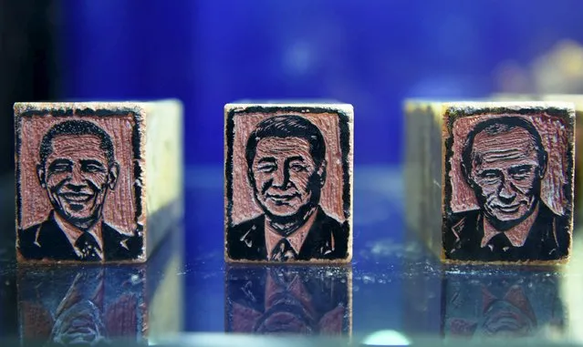 Seals which are carved to depict portraits of (L to R) U.S. President Barack Obama, Chinese President Xi Jinping and Russia President Vladimir Putin are displayed to mark the upcoming 2016 G20 Hangzhou Summit, in Hangzhou, Zhejiang province, China, October 19, 2015. It took local artist Qian Gaochao six months to make the 5-centimetre-long and 4-centimetre-wide seals for all the G20 countries leaders, local media reported. (Photo by Reuters/Stringer)