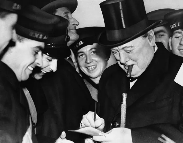 These British sailors seem pretty glad to get an autograph from the Boss, Winston Churchill, first lord of the British admiralty, who mingled with men from the cruisers Ajax and Exeter during the celebration, February 23, 1940 in London. Churchill (with cigar) was on hand to welcome home the men who helped drive the German pocked battleship, Admiral Graf Spee, to? suicide last December Off Uruguay. (Photo by AP Photo)