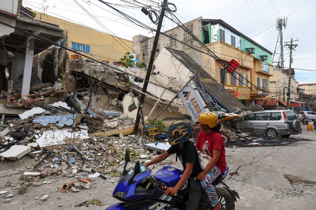 A car is crushed by the debris of partially collapsed buildings, following a magnitude 6.9 earthquake that jolted parts of the island, in Bogo City, Cebu, Philippines on October 01, 2025. Widespread damages to structures and properties, and multiple injuries and deaths have been reported following a powerful magnitude 6.9 earthquake that struck parts of Cebu on September 30. Local governments have declared a state of calamity in response to the situation, amid continued aftershocks. (Photo by Daniel Ceng/Anadolu via Getty Images)