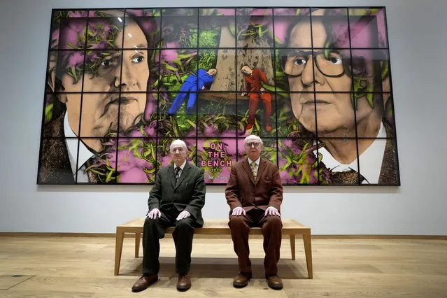 Gilbert and George sit with their artwork called On The Bench in their exhibition called The Paradisical Pictures at the opening of The Gilbert & George Centre in east London, Friday, March 24, 2023. (Photo by Kirsty Wigglesworth/AP Photo)
