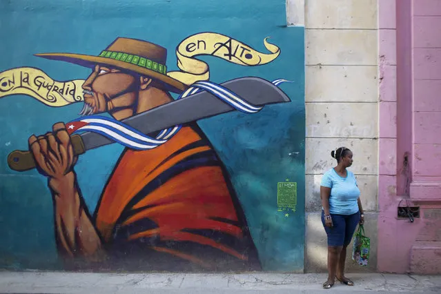 A woman stands on the street in downtown Havana December 19, 2014. (Photo by Alexandre Meneghini/Reuters)