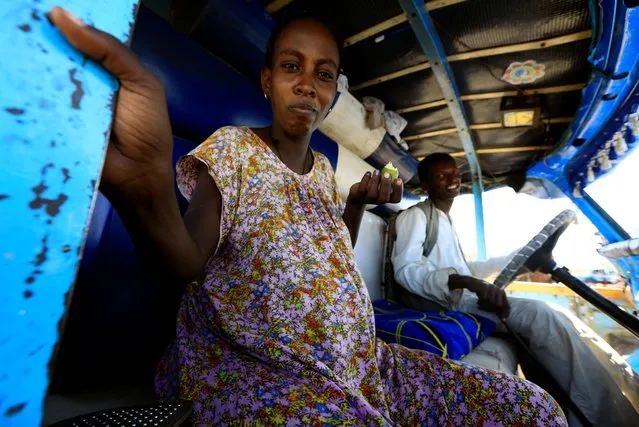 An Ethiopian pregnant refugee woman who fled Tigray region, sits inside a courtesy bus at the Fashaga camp as she is transferred to Um-Rakoba camp on the Sudan-Ethiopia border, in Kassala state, Sudan on December 13, 2020. (Photo by Mohamed Nureldin Abdallah/Reuters)