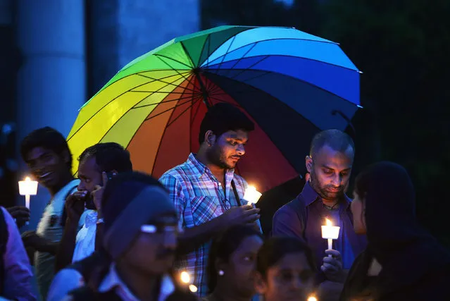 Transgender activists and their supporters take part in a candle light vigil held as part of "Transgender Day of Remembrance" in Bangalore on November 20, 2015. The Transgender Day of Remembrance is marked worldwide to remember members of the transgender community who have been murdered, and to raise awareness of the threat of violence and persistence of prejudice felt by the transgender community. (Photo by Manjunath Kiran/AFP Photo)