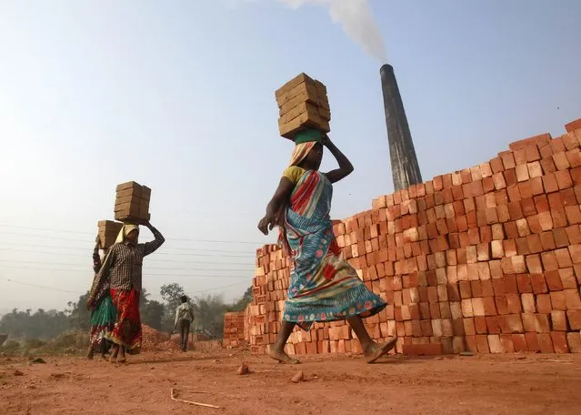 Labourers carry bricks at a brick factory on the outskirts of Agartala, capital of India's northeastern state of Tripura, January 7, 2015. A weak recovery from India's longest growth slowdown in decades is pushing Prime Minister Narendra Modi's advisers to consider loosening fiscal deficit targets, risking the ire of investors, ratings agencies and the central bank. (Photo by Jayanta Dey/Reuters)