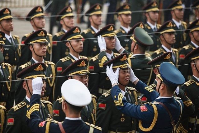 Members of the honour guard get ready for a welcoming ceremony for Spain's King Felipe VI at the Great Hall of People in Beijing on November 12, 2025. (Photo by Andrés Martínez Casares/AFP Photo)