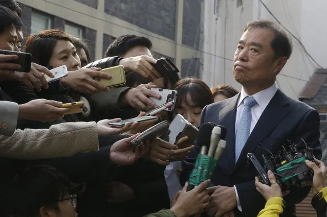 Newly appointed Prime Minister Kim Byong-joon, right, meets with media as he arrives his office in Seoul, South Korea, Thursday, November 3, 2016. South Korea's embattled President Park Geun-hye replaced her prime minister and two other top officials on Wednesday in a bid to restore public confidence amid a political scandal involving her longtime friend. (Photo by Ahn Young-joon/AP Photo)