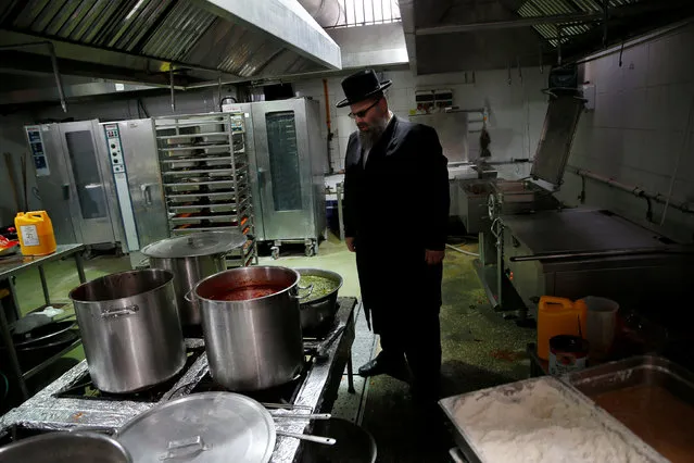 Kosher inspector Aaron Wulkan examines the kitchen of a catering business to check that it is kosher, ensuring that the food is stored and prepared according to Jewish regulations and customs, in Bat Yam, Israel October 31, 2016. (Photo by Baz Ratner/Reuters)