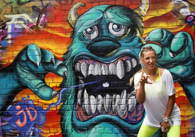 Two-time Australian Open tennis champion Victoria Azarenka of Belarus poses for a photograph in front of graffiti after a promotional event in Melbourne January 14, 2015. The Australian Open tennis tournament begins on January 19. (Photo by Reuters/Fiona Hamilton-Tennis Australia)
