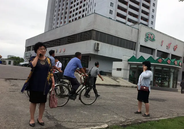 Residents go about their business near one of the city’s biggest department stores and shopping areas in Pyongyang, North Korea Sunday, June 10, 2018. Despite the focus of world attention on the upcoming summit in Singapore between US President Donald Trump and North Korean leader Kim Jong Un, many North Koreans remain in the dark about what is happening outside their isolated nation. (Photo by Eric Talmadge/AP Photo)