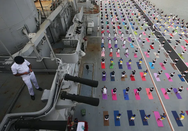 Members of the Indian Navy perform yoga on the flight deck of INS Viraat, an Indian Navy's decommissioned aircraft carrier, during International Yoga Day in Mumbai, India on June 21, 2018. (Photo by Francis Mascarenhas/Reuters)