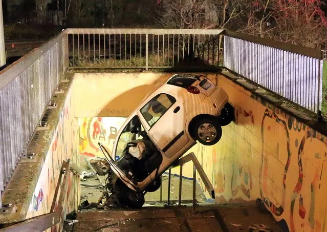 A crashed car in a railway pedestrian underpass in Bad Staffelstein, Germany, 14 December 2015. A man with a 2.5 per mille blood alcohol level crashed into the underpass after going into a corner too fast and coming off the road. (Photo by EPA/News5/Merzbach)