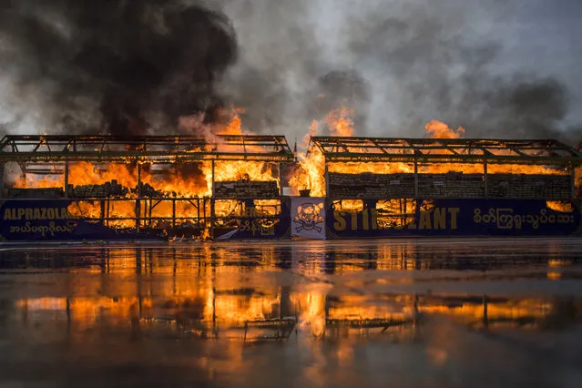 Myanmar law enforcement authorities burn seized illegal drugs worth 187 million USD marking the International Day against Drug Abuse and Illicit Trafficking during a ceremony in Yangon on June 26, 2018. The ceremony was among several destruction events that took place on June 26 across Southeast Asia, home to the infamous “Golden Triangle”, a zone bisecting Thailand, Myanmar, China and Laos that is the world's second largest drug producing area. (Photo by Ye Aung Thu/AFP Photo)