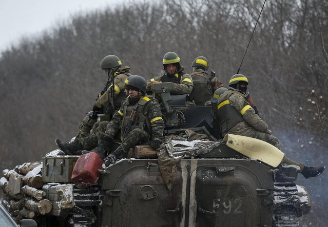 Members of the Ukrainian armed forces ride on an armoured personnel carrier (APC) near Debaltseve, eastern Ukraine, February 10, 2015. (Photo by Gleb Garanich/Reuters)