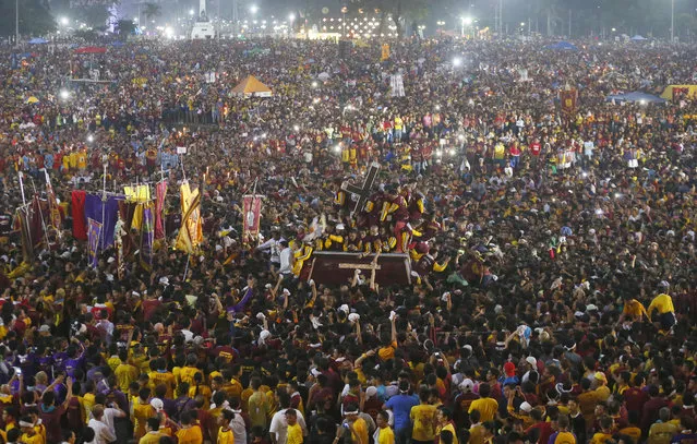 Tens of thousands of Catholic devotees jostle to get closer to the image of the Black Nazarene as they take part in a raucous procession to celebrate its feast day in Manila, Philippines, Saturday, January 9, 2016. (Photo by Bullit Marquez/AP Photo)