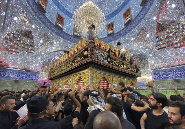 Shiite worshippers visit the holy shrine of Imam Abbas during Muharram processions in Karbala, Iraq, Saturday, July. 29, 2023. Muharram is among the holiest months for Shiite Muslims and marks Ashoura, commemorating the 7th century martyrdom of the Prophet Muhammad’s grandson Imam Hussein. (Photo by Hadi Mizban/AP Photo)