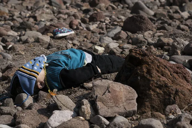 The lifeless body of a migrant boy lies on the beach near the Aegean town of Ayvacik, Canakkale, Turkey, Saturday, January 30, 2016. (Photo by Halit Onur Sandal/AP Photo)