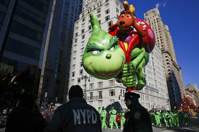 The Grinch balloon floats over Central Park West during the 92nd annual Macy's Thanksgiving Day Parade in New York, Thursday, November 22, 2018. (Photo by Eduardo Munoz Alvarez/AP Photo)