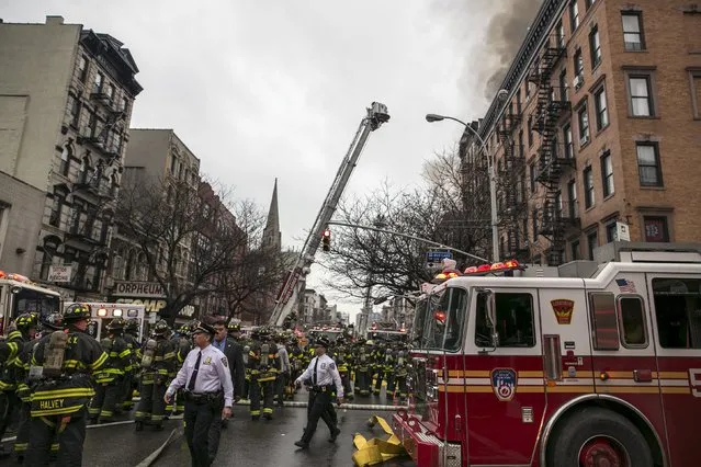 Police and firefighters surround the site of a building fire in the East Village neighborhood of New York City on March 26, 2015. (Photo by Ben Hider/Reuters)
