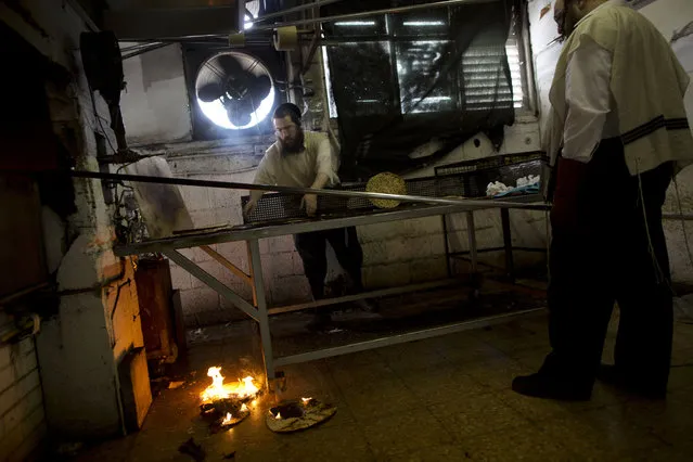 Ultra-Orthodox Jews prepare special matzoh, a traditional handmade Passover unleavened bread, at a bakery in Bnei Brak near Tel Aviv, Israel. Thursday, April 10, 2014. (Photo by Oded Balilty/AP Photo)