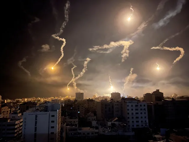 Flares are dropped by Israeli forces, amid the ongoing conflict between Israel and Palestinian Islamist group Hamas, in Gaza City on November 6, 2023. (Photo by Mohammed Al-Masri/Reuters)