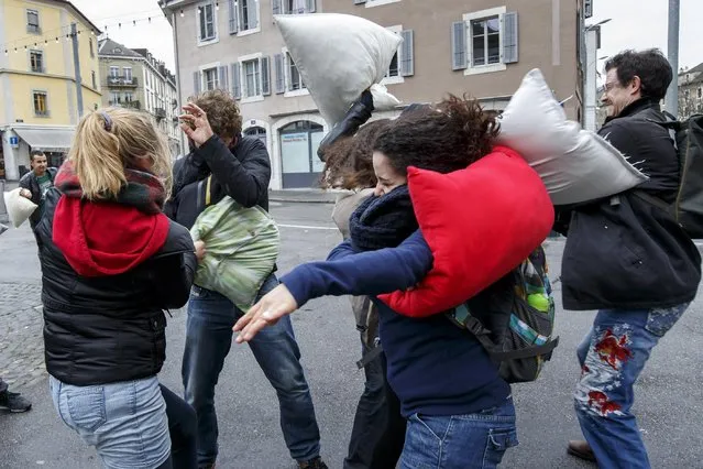 Young people fight for  fun with their pillows, during the International Pillow Fight Day at the Place des Grottes, in Geneva, Switzerland, Saturday, April 4, 2015. (Photo by Salvatore Di Nolfi/AP Photo/Keystone)