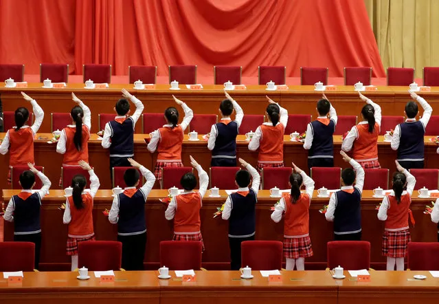 Students prepare for an event marking the 40th anniversary of China's reform and opening up at the Great Hall of the People in Beijing, China December 18, 2018. (Photo by Jason Lee/Reuters)