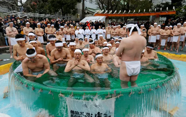 People wearing loin cloths pray as they bathe in ice-cold water outside the Teppozu Inari shrine in Tokyo, Japan, January 8, 2017. (Photo by Toru Hanai/Reuters)