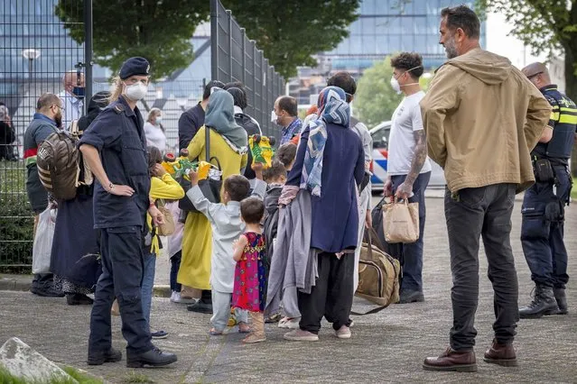Evacuees from Afghanistan arrive at the Marine Etablissement Amsterdam site in Amsterdam, the Netherlands, 26 August 2021. Defense makes part of the Marine Etablissement Amsterdam available as an emergency reception location for evacuees from Afghanistan. The COA can accommodate approximately 350 evacuees. It is the fifth emergency shelter in the country. (Photo by Ramon van Flymen/EPA/EFE)