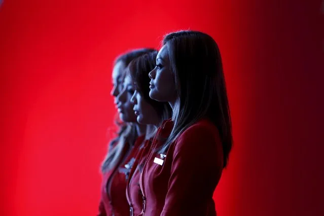 Flight attendants of the long-haul carrier AirAsia X watch a performance during the launch of the company's prospectus in Kuala Lumpur in this June 10, 2013 file photo. AirAsiaX is expected to report Q4 results this week. (Photo by Bazuki Muhammad/Reuters)