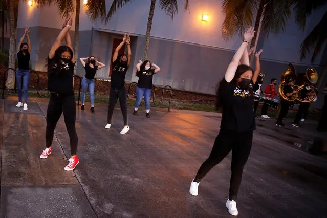 School cheerleaders wearing protective masks perform as fellow students arrive for classes on the first day of school in Miami-Dade County at Barbara Goleman Senior High School, in Miami, Florida, August 23, 2021. (Photo by Marco Bello/Reuters)