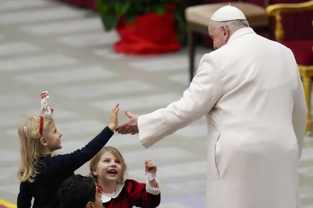 Pope Francis is greeted by children as he celebrates his birthday with children assisted by the Santa Marta dispensary during an audience in the Paul VI Hall, at the Vatican, Sunday, December 17, 2023. Pope Francis turnes 87 on Dec.17. (Photo by Alessandra Tarantino/AP Photo)