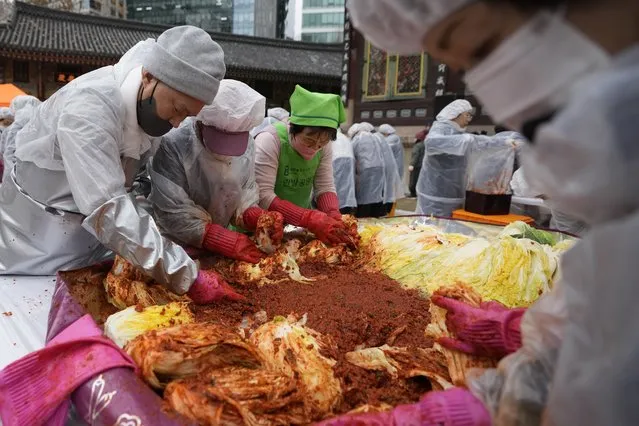 Buddhist monks and Buddhist practitioners make kimchi, a staple Korean side dish, at Jogye temple in Seoul, South Korea, Wednesday, November 29, 2023. They will donate about 3,000 packets of kimchi to needy neighbors in preparation for the winter season. (Photo by Lee Jin-man/AP Photo)