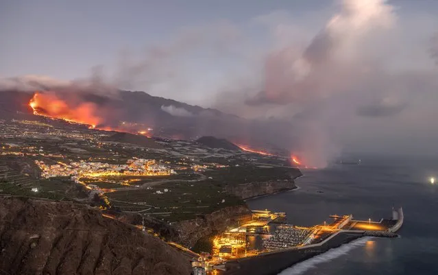 Lava from a volcano reaches the sea on the Canary island of La Palma, Spain, Wednesday September 29, 2021. Lava from a volcano on Spain's Canary Islands has finally reached the Atlantic Ocean after days of wiping out hundreds of homes and forcing the evacuation of thousands of residents. (Photo by Saul Santos/AP Photo)