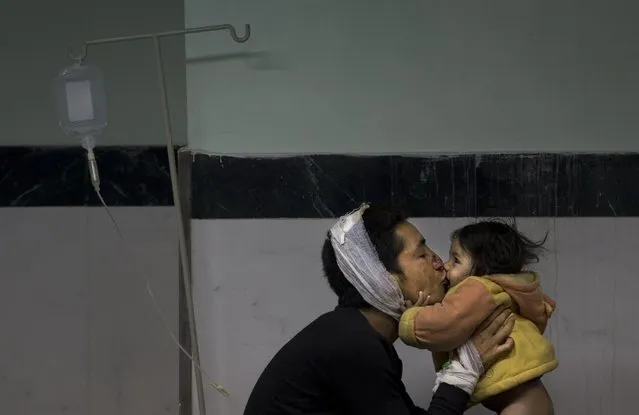 Earthquake injured Nepalese man Suresh Parihar plays with his daughter Sandhya at a hospital, in Kathmandu, Nepal, Sunday, April 26, 2015. (Photo by Manish Swarup/AP Photo)