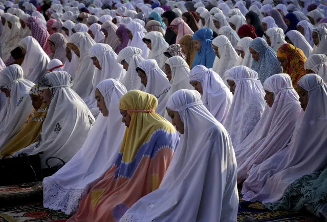 Muslim women perform an eclipse prayer during a partial solar eclipse at a mosque in Banda Aceh, Aceh province, Wednesday, March 9, 2016. (Photo by Heri Juanda/AP Photo)