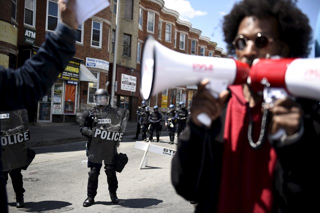 A protester yells “register to vote” near the condemned CVS Pharmacy building on Pennsylvania Avenue in Baltimore April 28, 2015. (Photo by Sait Serkan Gurbuz/Reuters)