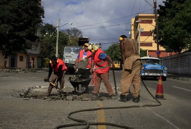 Men work on a street near Cuban baseball national stadium February 28, 2016. (Photo by Enrique de la Osa/Reuters)