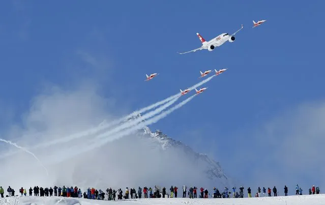 Members of the Swiss aerobatic team Patrouille Swiss fly in formation with a Swiss Bombardier CS100 over the men's Alpine Skiing World Championships in St. Moritz, Switzerland, February 11, 2017. (Photo by Denis Balibouse/Reuters)