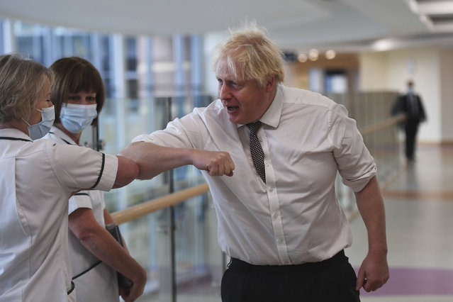 Britain's Prime Minister Boris Johnson meets with medical staff during a visit to Hexham General Hospital in Northumberland, England, Monday, November 8, 2021. (Photo by Peter Summers/Pool Photo via AP Photo)