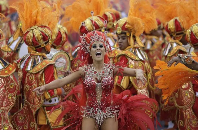 A dancer from the Tom Maior samba school performs during a carnival parade in Sao Paulo, Brazil, Saturday, March 1, 2014. (Photo by Andre Penner/AP Photo)