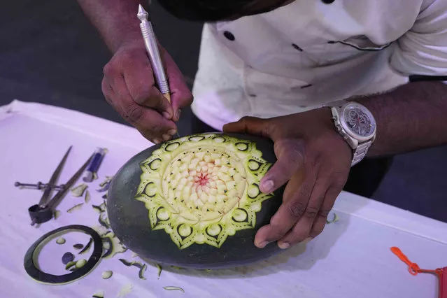 Chef Jagan S makes mandala art on a watermelon during the Food for Thought Fest in Ahmedabad, India, Friday, March 8, 2024. The Food for Thought Fest, organised by South Asian Association for Gastronomy, showcases the diverse culinary heritage of the South Asian region and cuisines. (Photo by Ajit Solanki/AP Photo)