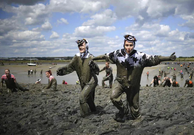Competitors take part in the annual Maldon Mud Race, a charity event to race across the bed of the River Blackwater in Maldon, southern England on Sunday May 12, 2019. (Photo by Joe Giddens/PA Wire via AP Photo)