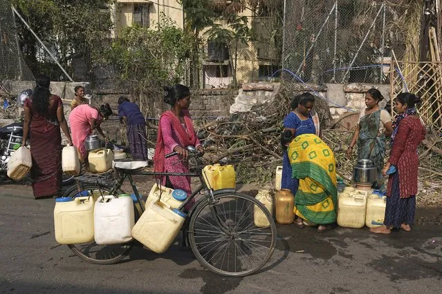 Women collect water from a public tap on World Water Day in Hyderabad, India, Friday, March 22, 2024. (Photo by Mahesh Kumar A./AP Photo)