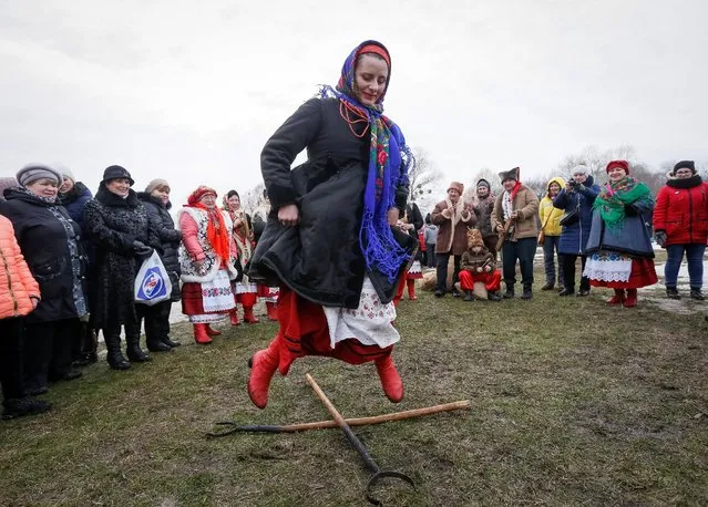 A reveller takes part in a festive game during the celebration of Maslenitsa also known as Kolodiy, a pagan holiday marking the end of winter, in Kiev, Ukraine, February 26, 2017. (Photo by Vasily Fedosenko/Reuters)