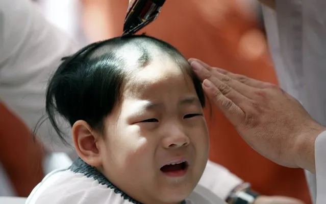 A boy has his hair shaved during the 'Children becoming Buddhist monks' ceremony at the Jogyesa temple in Seoul, South Korea, 22 April 2019. The children will stay at the temple to learn about Buddhism for 21 days. South Korean Buddhists prepare to celebrate Buddha's upcoming birthday on 12 May. (Photo by Jeon Heon-Kyun/EPA/EFE/Rex Features/Shutterstock)