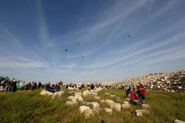 People fly kites during an event celebrating spring at the Citadel in Amman, Jordan, April 15, 2016. (Photo by Muhammad Hamed/Reuters)