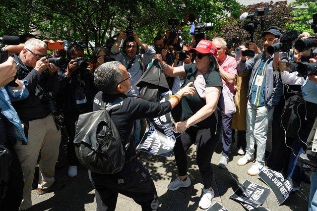 An anti-Trump protester (L) and a pro-Trump supporter (R) get into a dispute as they wait for a verdict in the criminal trial of former US President and Republican presidential candidate Donald Trump, in Collect Pond Park across the street from Manhattan Criminal Court on May 30, 2024 in New York City. Jurors return Thursday to a second day of deliberations in Donald Trump's criminal trial, leaving the Republican presidential candidate and the country waiting for a decision that could upend November's election. (Photo by Timothy A. Clary/AFP Photo)